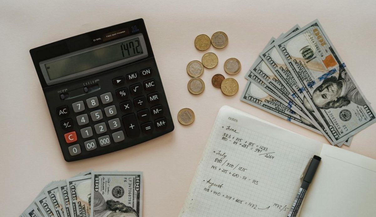 Calculator, cash, coins, and budget notes