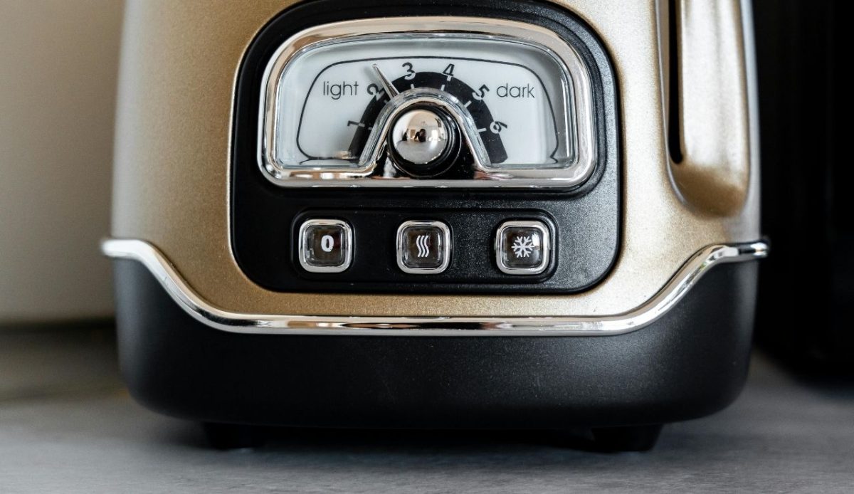 Close up of a toaster control panel with browning settings and function buttons
