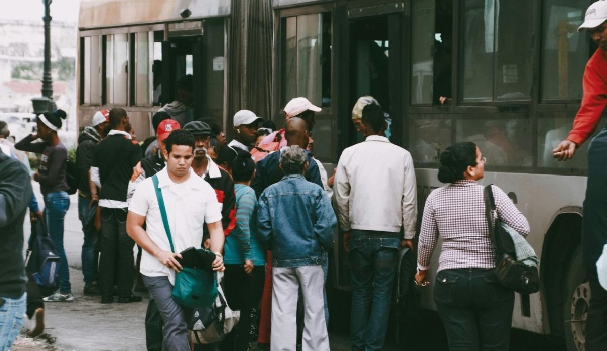 Crowd of people boarding a bus