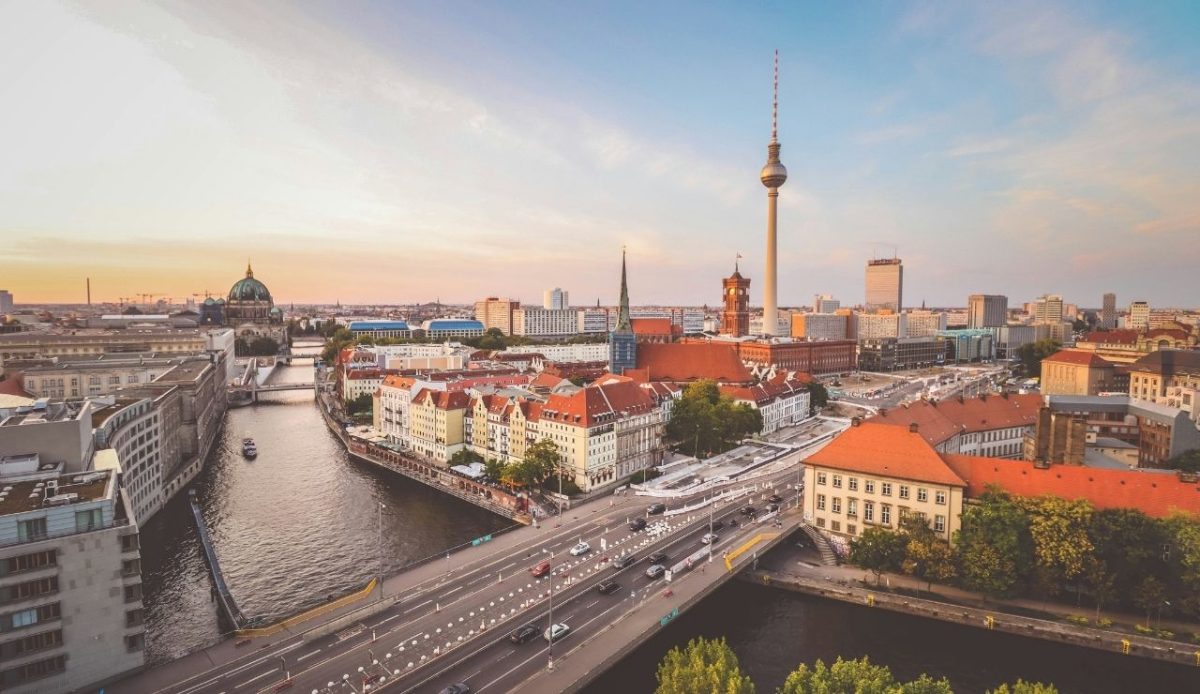 Aerial view of Berlin with the TV Tower, cathedral, and river at sunset
