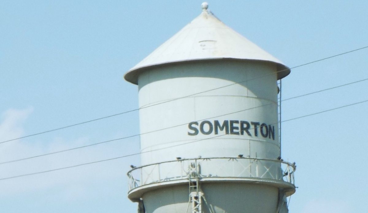 10 Arizona Cities Retirees Often Avoid Living In 7 Somerton, Arizona Water tower with SOMERTON written on it under a blue sky By