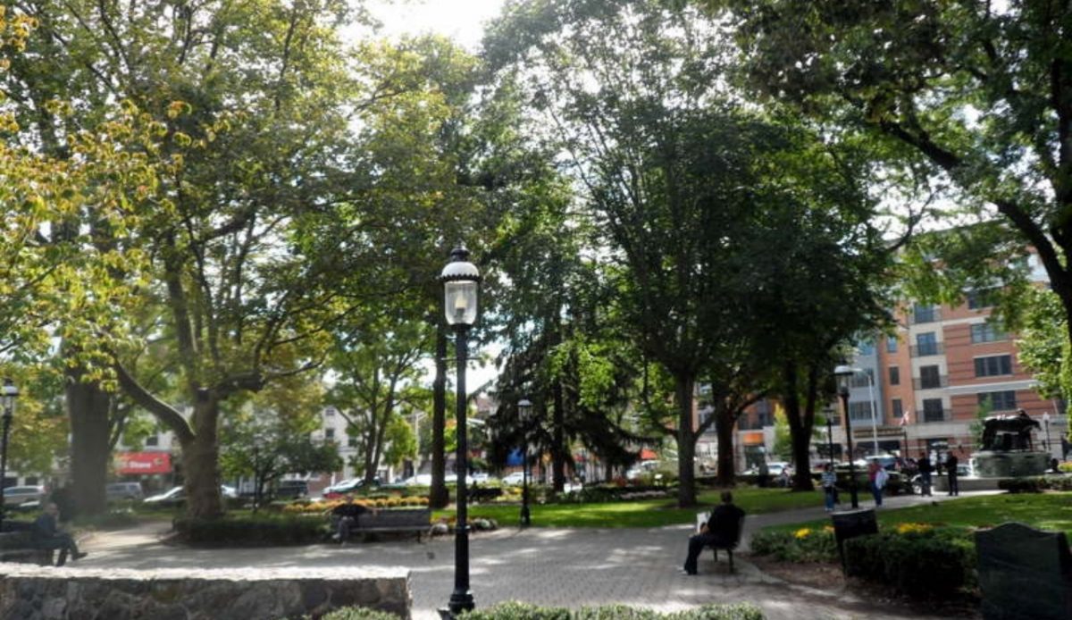 Green park with trees, benches, and people, located in Morristown, New Jersey 