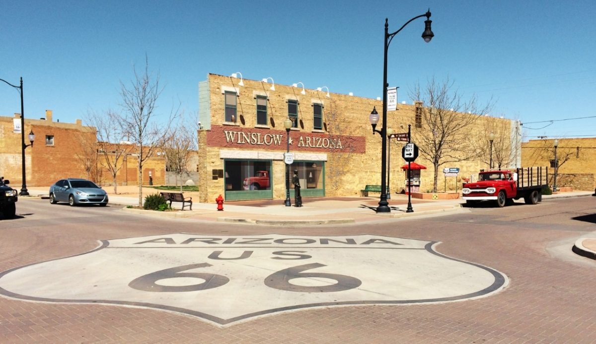 10 Arizona Cities Retirees Often Avoid Living In 9 Winslow, Arizona Route 66 marker at the iconic Standing on the Corner park