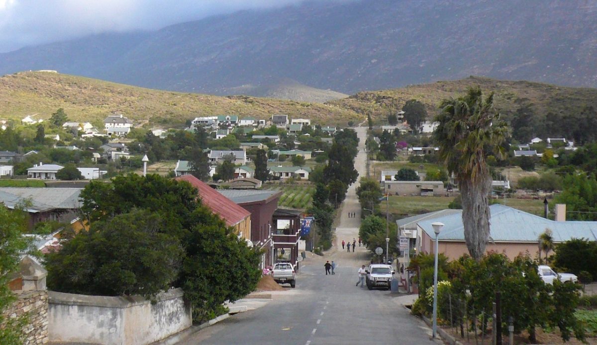15 Small Towns in South Africa Travelers Should Visit Now 14 Main street view of Barrydale village in the Western Cape, South Africa, with mountains in the background