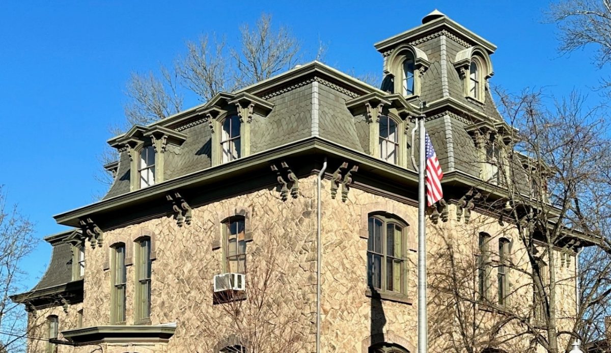 Historic stone building with a large green roof,and clear blue sky,Lambertville, New Jersey 