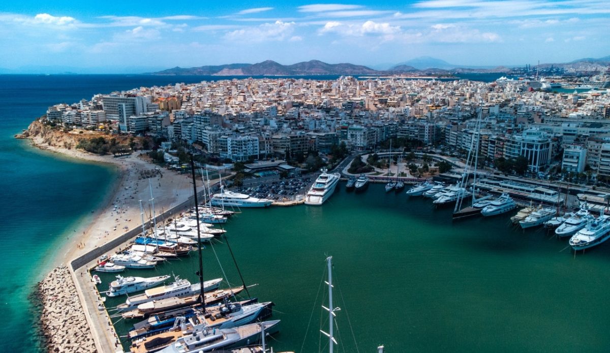 Aerial view of Piraeus, Greece, with yachts docked at the harbor and cityscape 