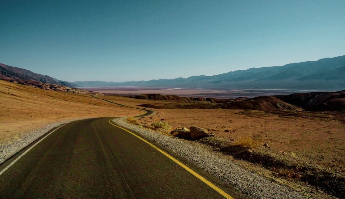 Desolate road, Death Valley, California, winding through desert landscape 