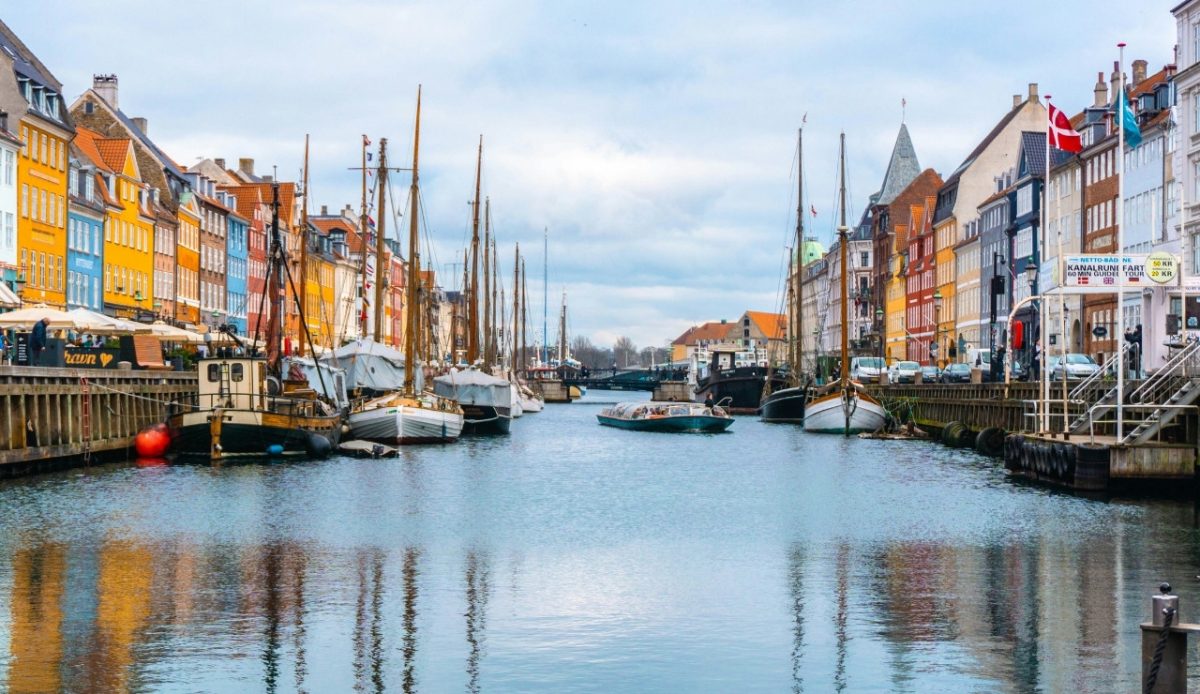 Nyhavn Harbor in Copenhagen, Denmark, with colorful buildings and boats 