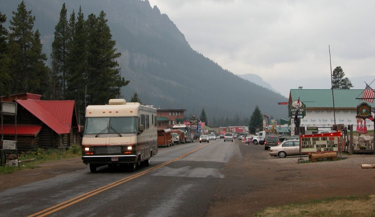 Entering Cooke City, Montana, with RV and mountain views along the road 