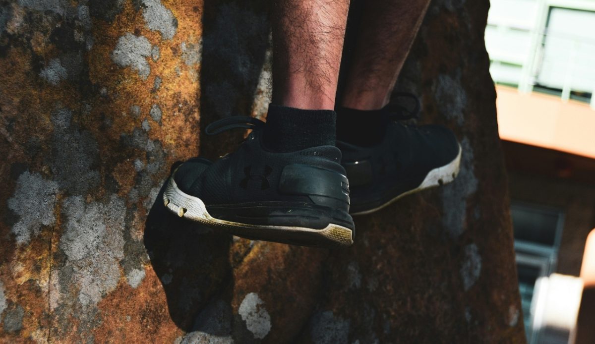 12 Common Mistakes Travelers Make When Visiting National Parks 7 Person climbing rock, wearing black Under Armour sneakers