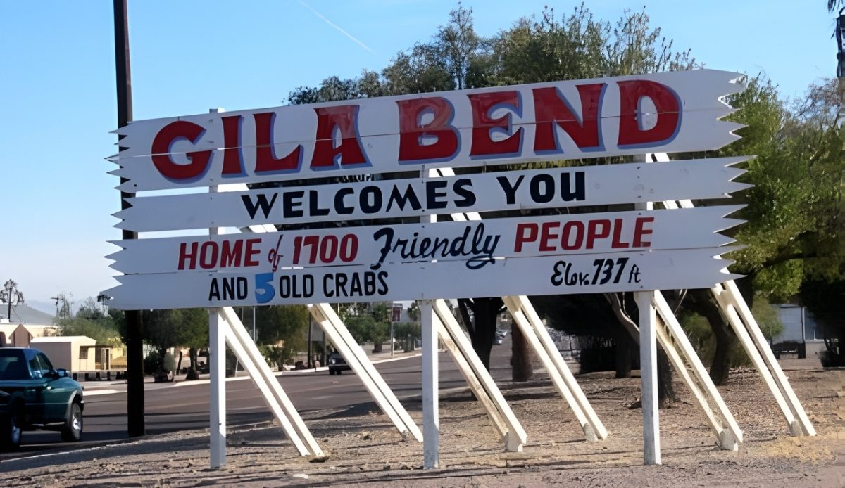10 Arizona Cities Retirees Often Avoid Living In 5 Gila Bend, Arizona Welcome sign with Home of 1700 Friendly People and 5 Old Crabs