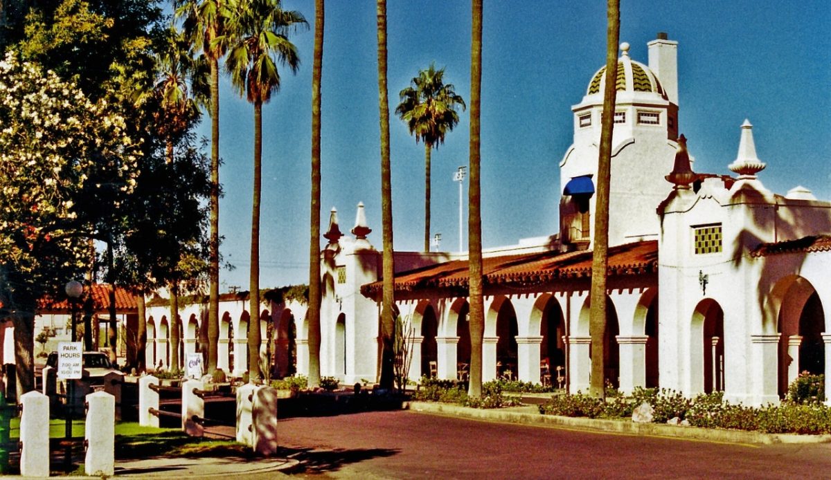 10 Arizona Cities Retirees Often Avoid Living In 6 Ajo, Arizona Historic plaza with Spanish-style architecture and tall palm trees