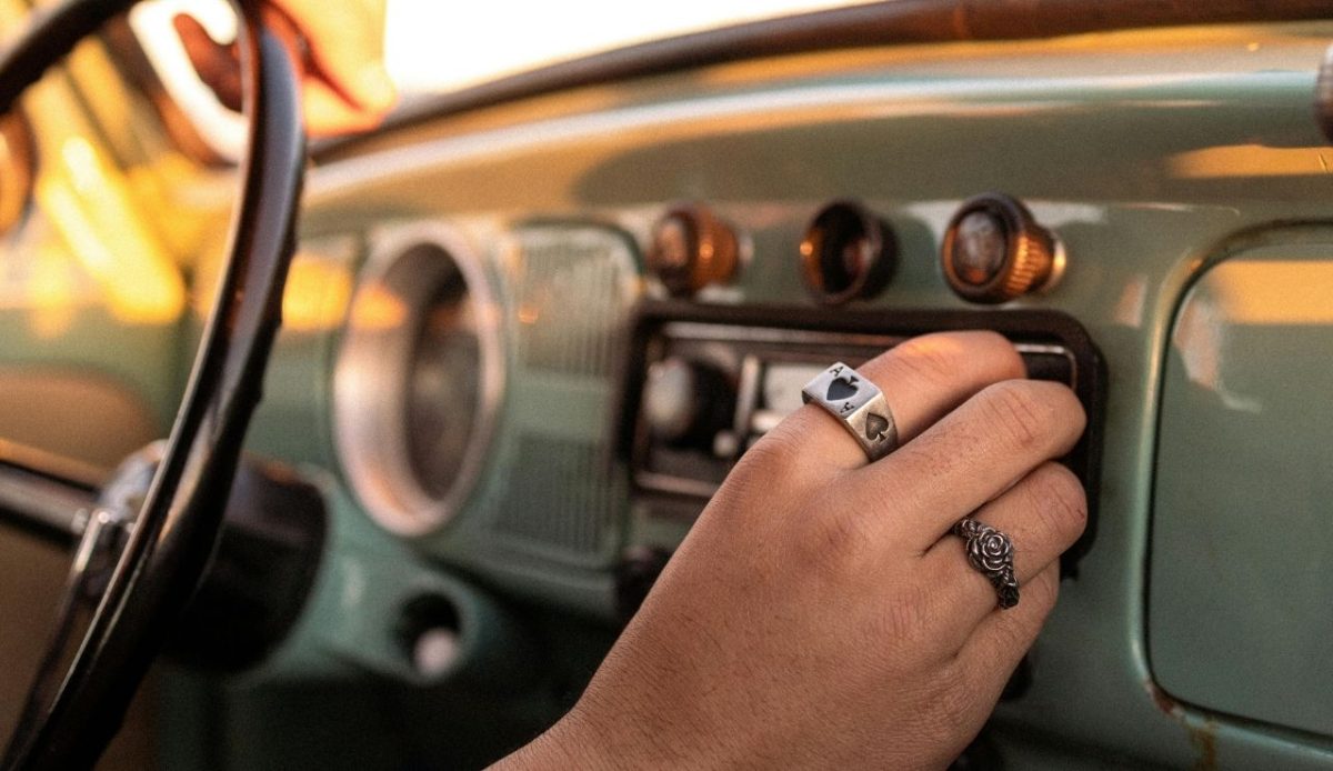 9 Road Trip Tips To Make Your Journey Fun And Memorable 7 A Person Turning on the Car Radio