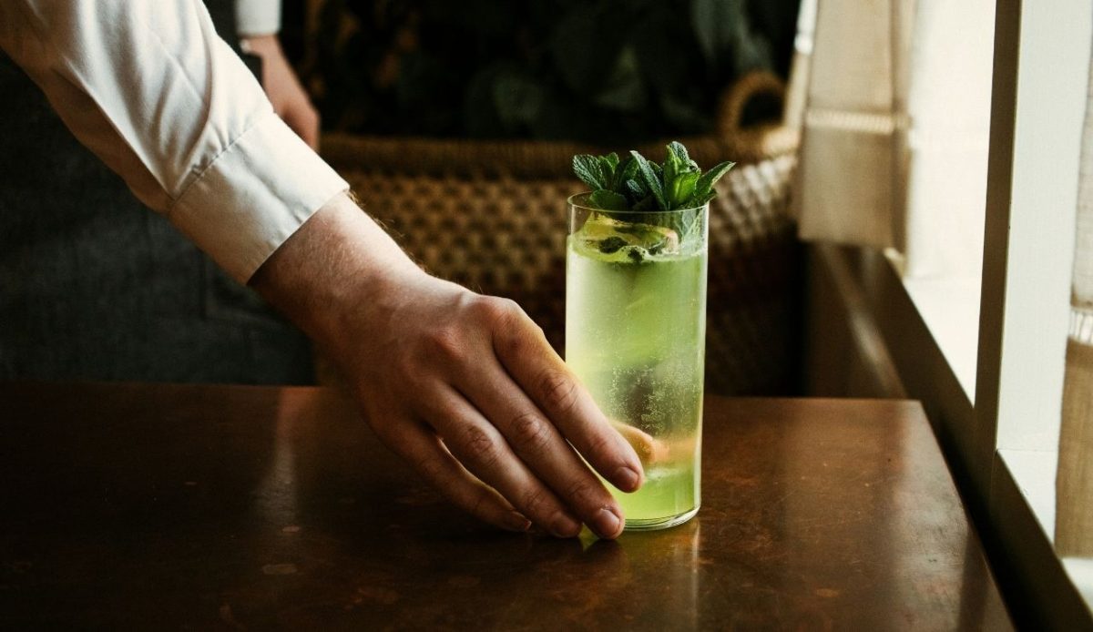 A person holding glass of drink      