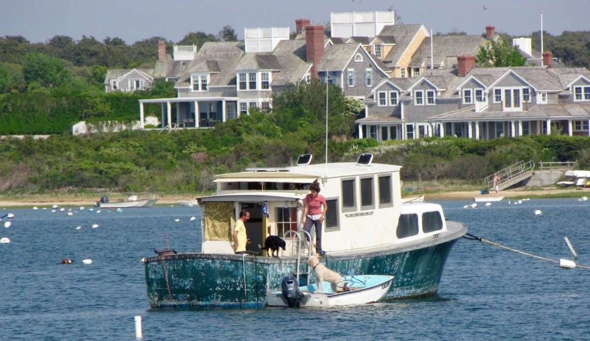 14 Charming Downtowns That Impress Without Skyscrapers 3 Boat anchored near Nantucket harbor with houses in the background