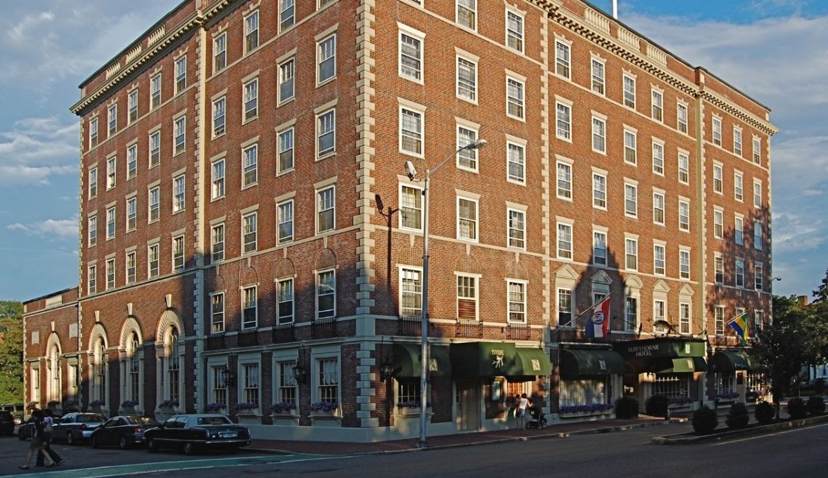 13 Haunted Places in the US Where You Can Spend the Night 3 Brick exterior of the historic Hawthorne Hotel under evening light, Salem, Massachusetts, USA