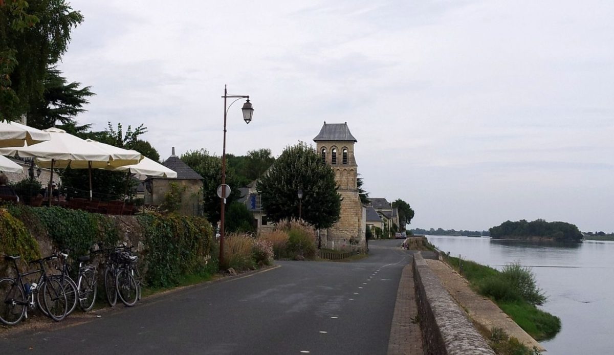 12 Scenic Bike Tours Around the World Worth Every Mile 11 Café terrace and riverside road in Le Thoureil, Maine-et-Loire, France