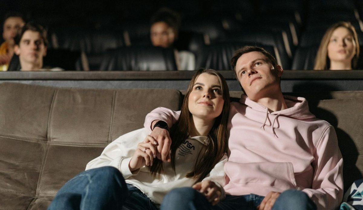 12 Romantic Things for Couples to Do in Nashville TN 3 Couple sitting together and watching in a cozy theater, holding hands and smiling