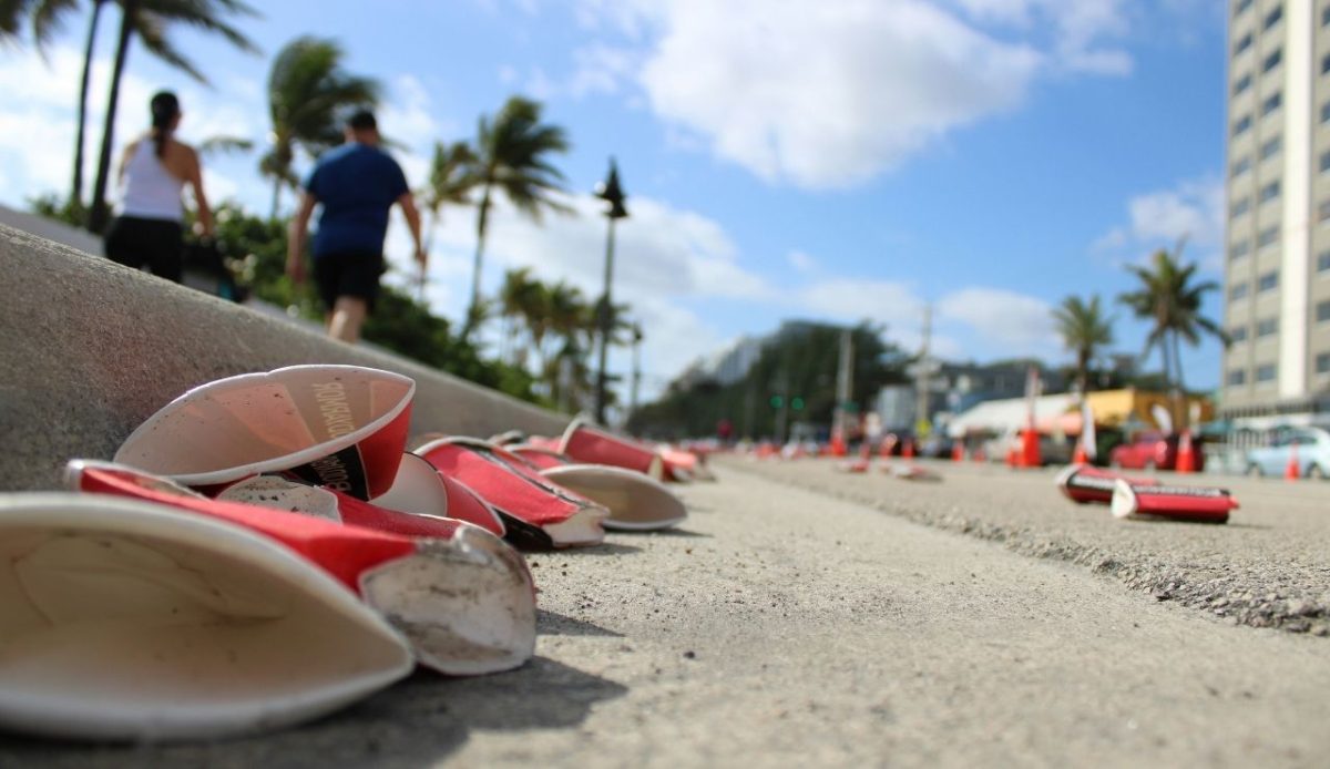 Discarded paper cups garbage line in a sunny street      