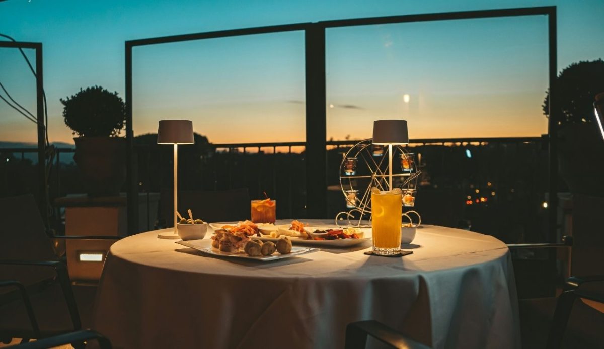 12 Romantic Things for Couples to Do in Nashville TN 1 Evening rooftop dining setup with cocktails and appetizers at sunset