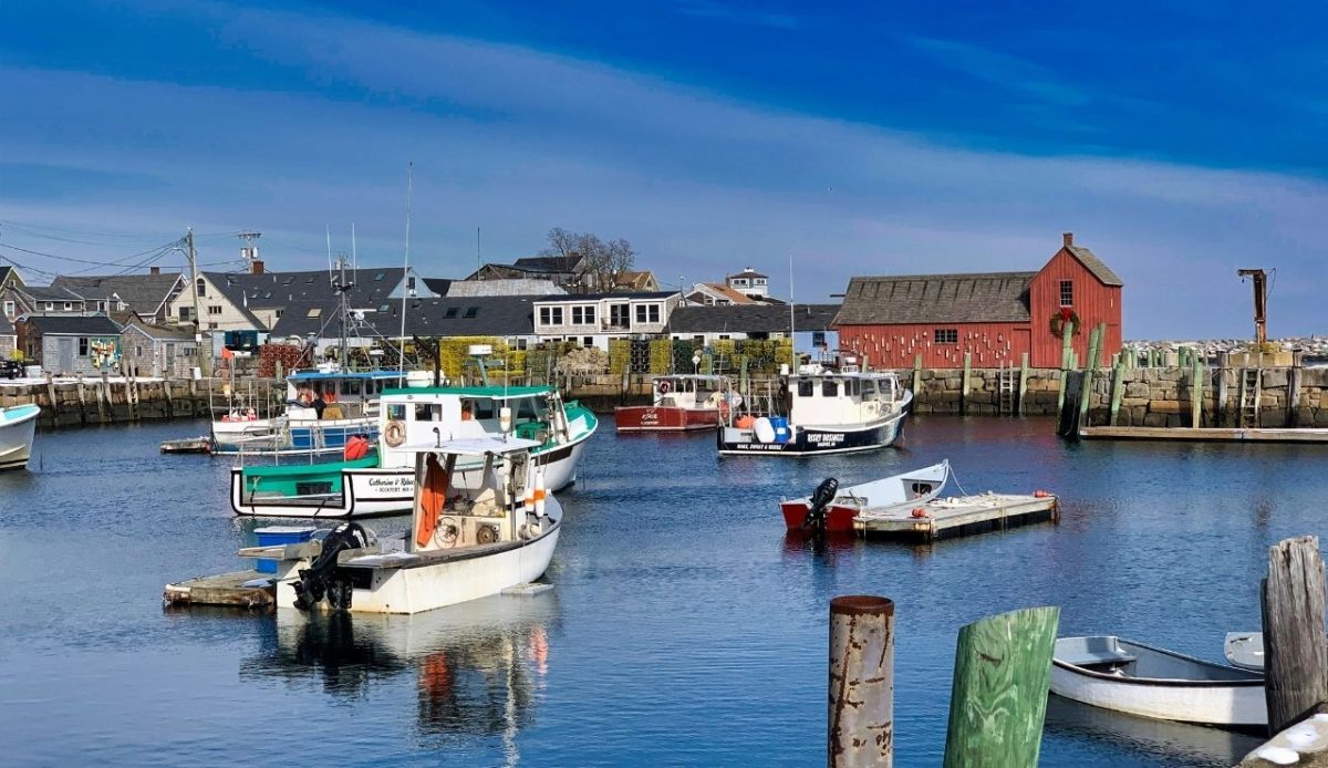 8 Peaceful Northeast Beach Towns to Visit and 4 Better Skipped 5 Fishing boats docked beside the red Motif Number 1 building in Rockport Harbor, Rockport, Massachusetts, USA