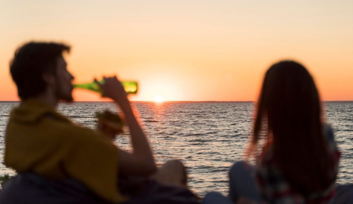 Inside the Famous Hula Hula Party in Hvar, Croatia 2 Friends admiring the sunset while drinking a beer