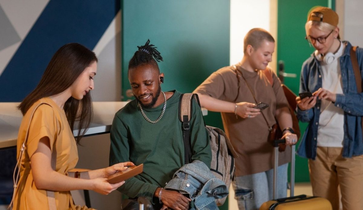 The Unspoken Rules of Airport Lounges and Why They Matter 7 Friends chatting at a lobby with luggage and travel bags