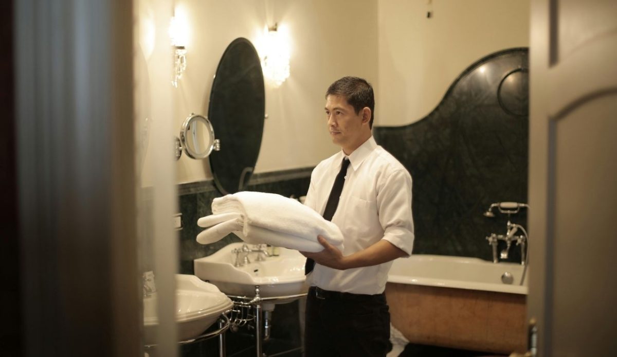 12 Annoying Things Guests Do At Hotels Without Realizing It 8 Hotel staff (housekeeper) holding fresh towels in bathroom