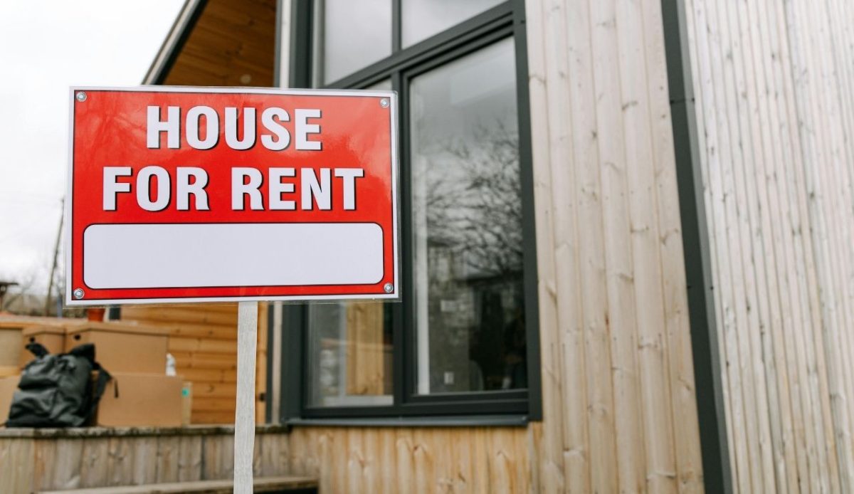 House for rent sign outside wooden home