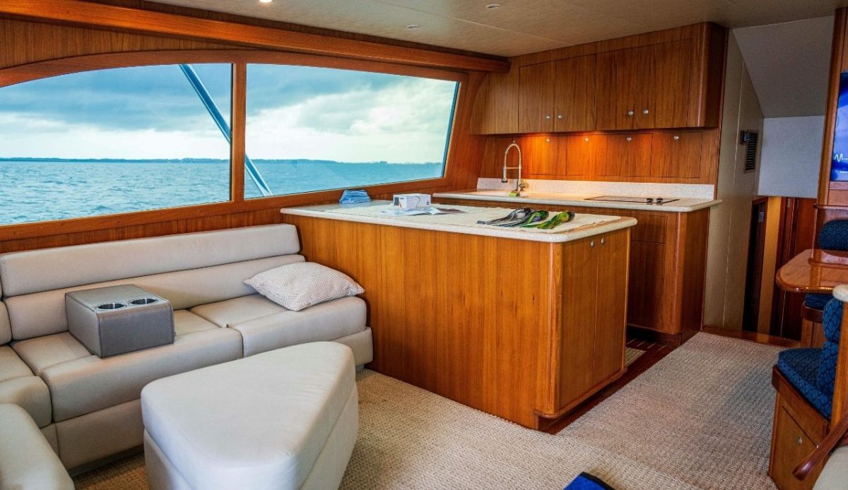 Interior of a modern yacht with a wooden kitchen and ocean view