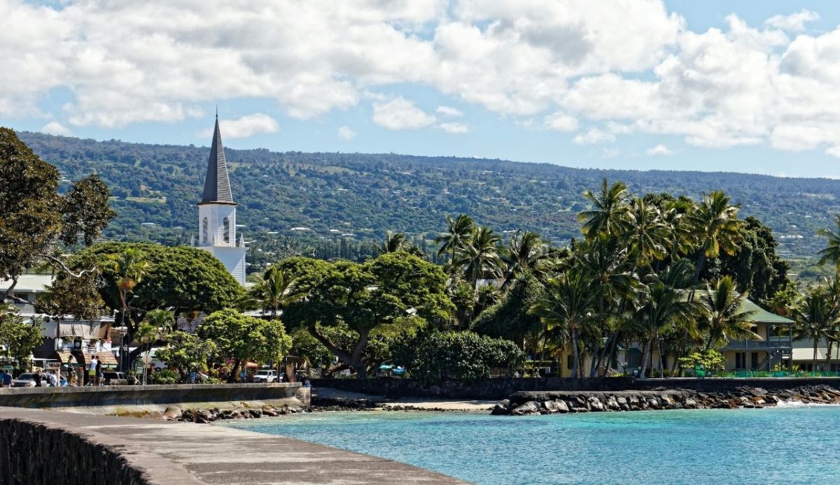 9 Best Hawaiian Islands to Visit for Every Kind of Traveler 8 Kailua-Kona waterfront with palm trees and Mokuaikaua Church steeple