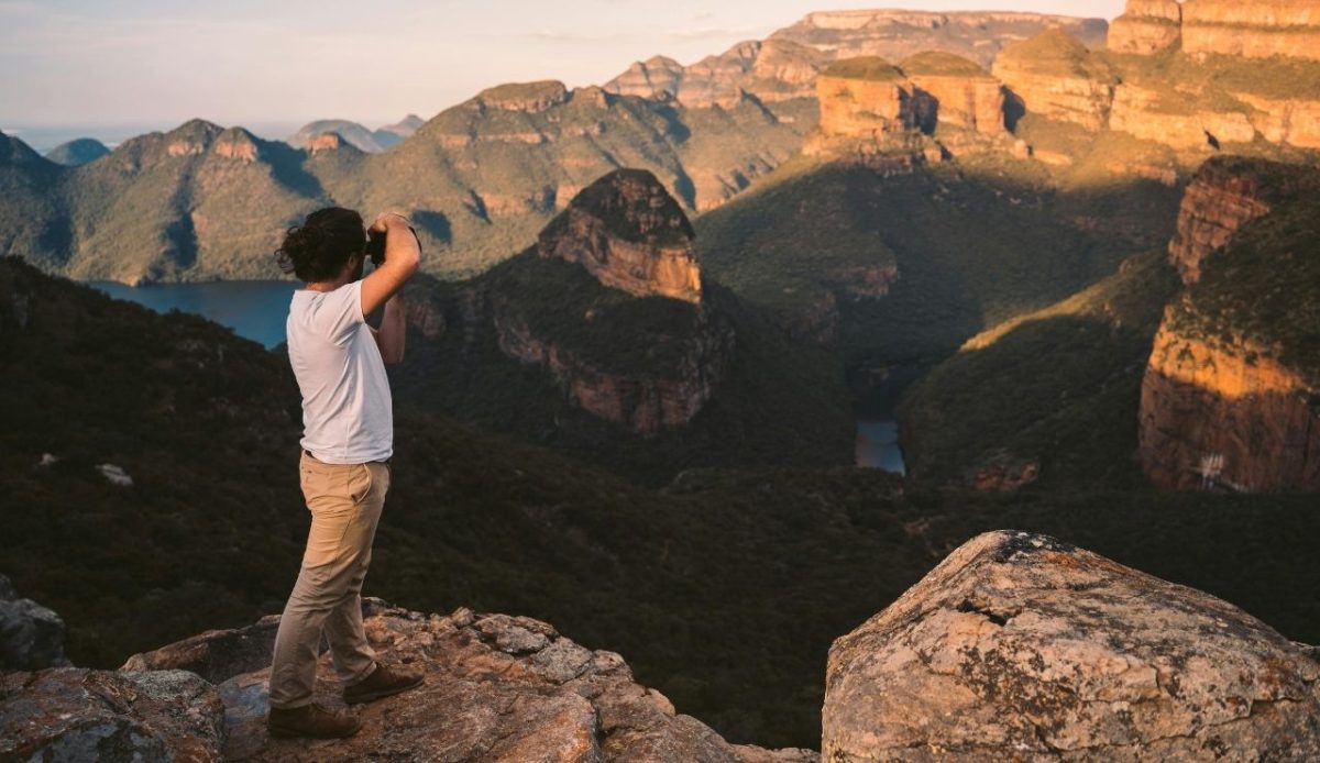 12 Common Mistakes Travelers Make When Visiting National Parks 12 Man Standing on the Edge of a Cliff while Taking Pictures