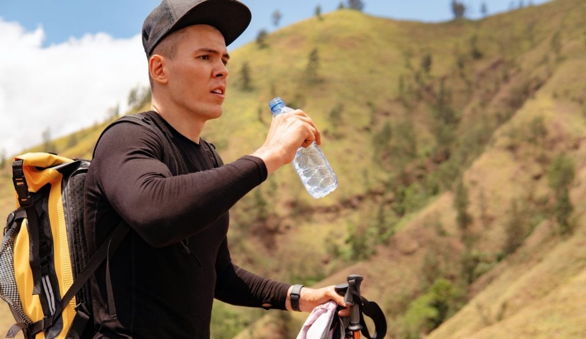 12 Common Mistakes Travelers Make When Visiting National Parks 6 Man drinking water trekking in the mountains rekking in the mountains