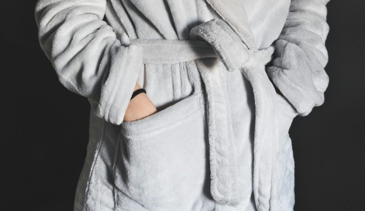 12 Annoying Things Guests Do At Hotels Without Realizing It 12 Person wearing a soft gray bathrobe with hands in pockets