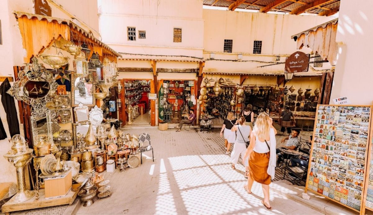 Photo of People Walking in Marketplace of small town      