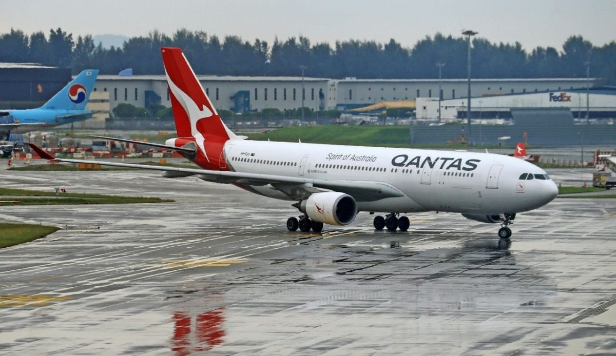 Qantas Airbus A330 taxiing on wet runway at airport