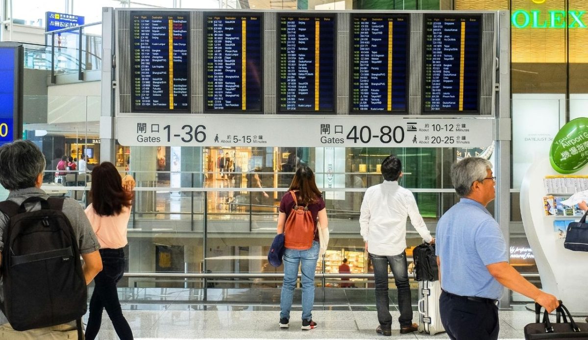Why Fewer Chinese Tourists Are Visiting the U.S. This Year 6 People Standing Near Airport Departure Board AirTeo