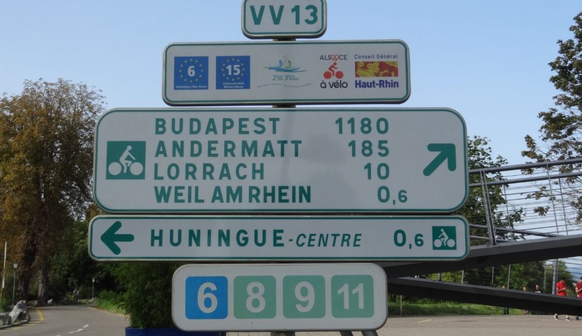 12 Scenic Bike Tours Around the World Worth Every Mile 2 Route sign of EV6 and EV15 in Huningue, France