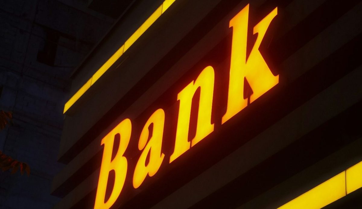 Glowing yellow bank sign at night