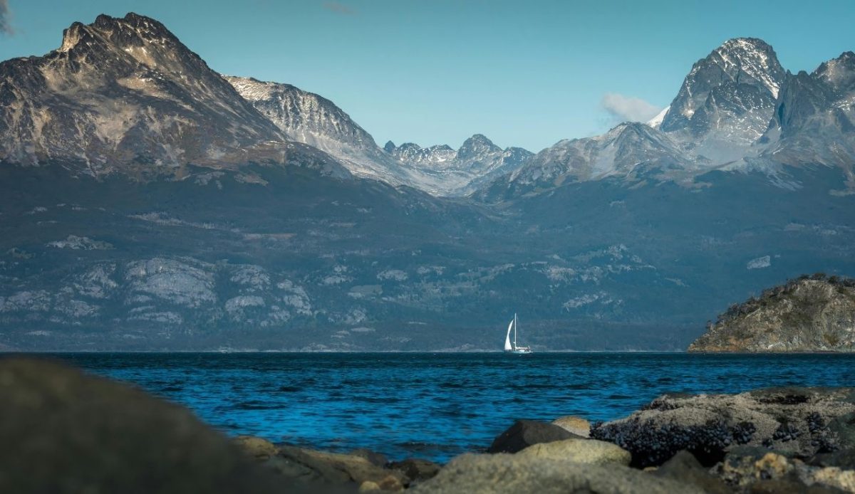 Sailboat on the Beagle Channel with snow-capped Andes mountains in Ushuaia, Argentina