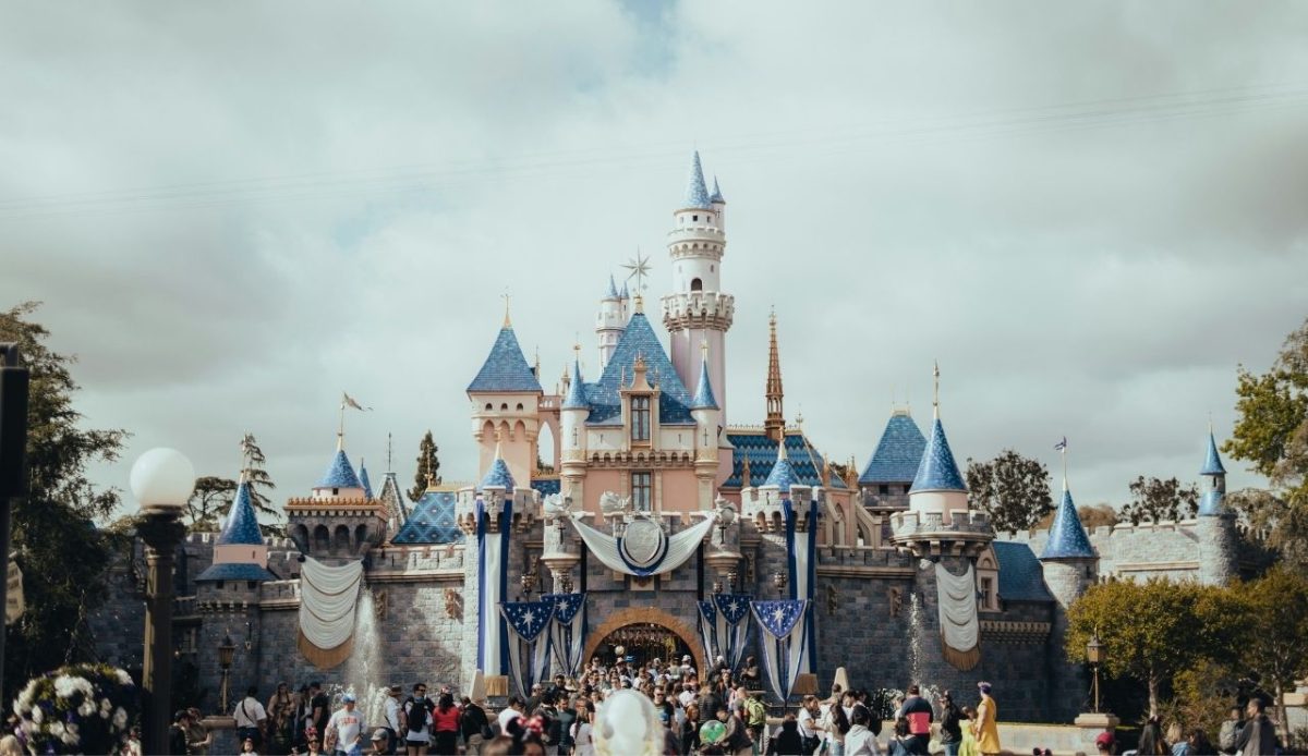 Inside the Abandoned Disney Resort With a Complicated Past 5 Sleeping Beauty Castle at Disneyland with visitors gathered in front of castle