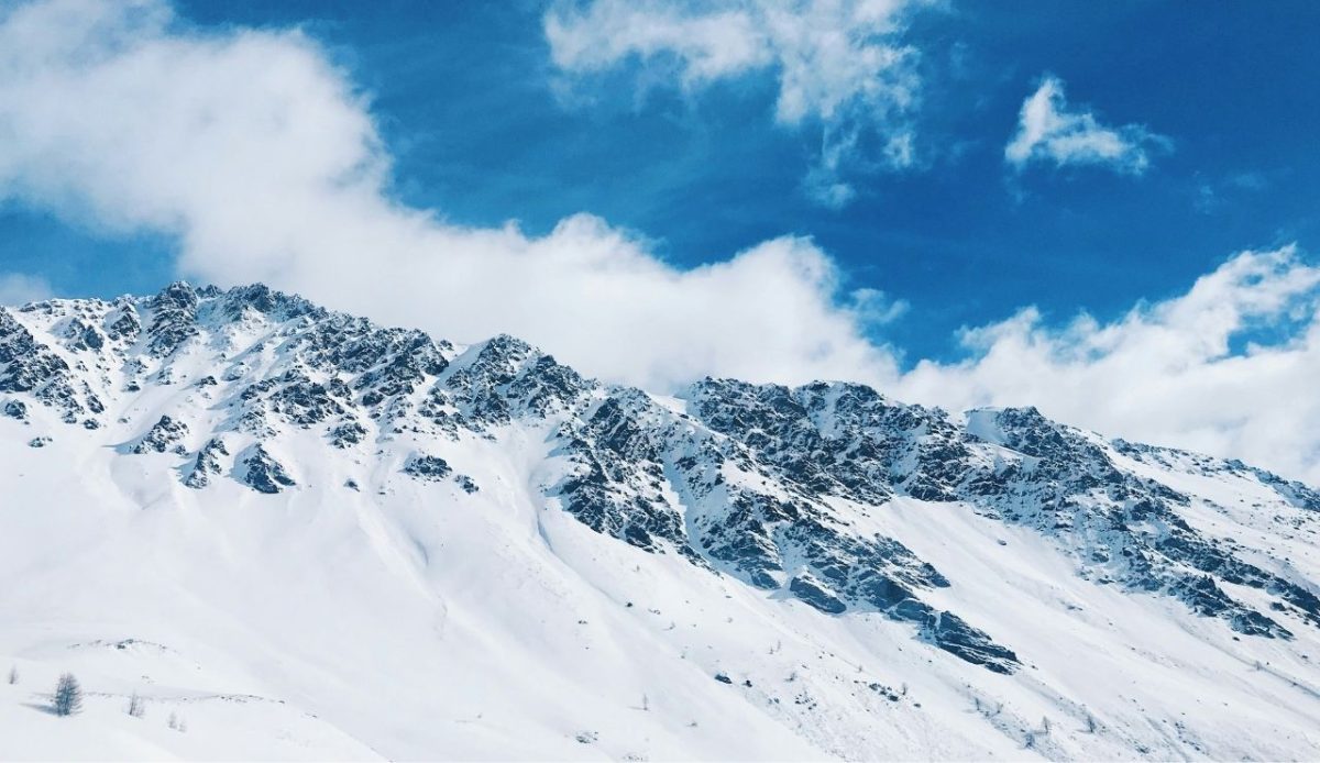 10 Best Ski Resorts in Italy Every Skier Should Visit 8 Snow-covered mountain peaks under bright blue sky in Livigno, Lombardy, Italy
