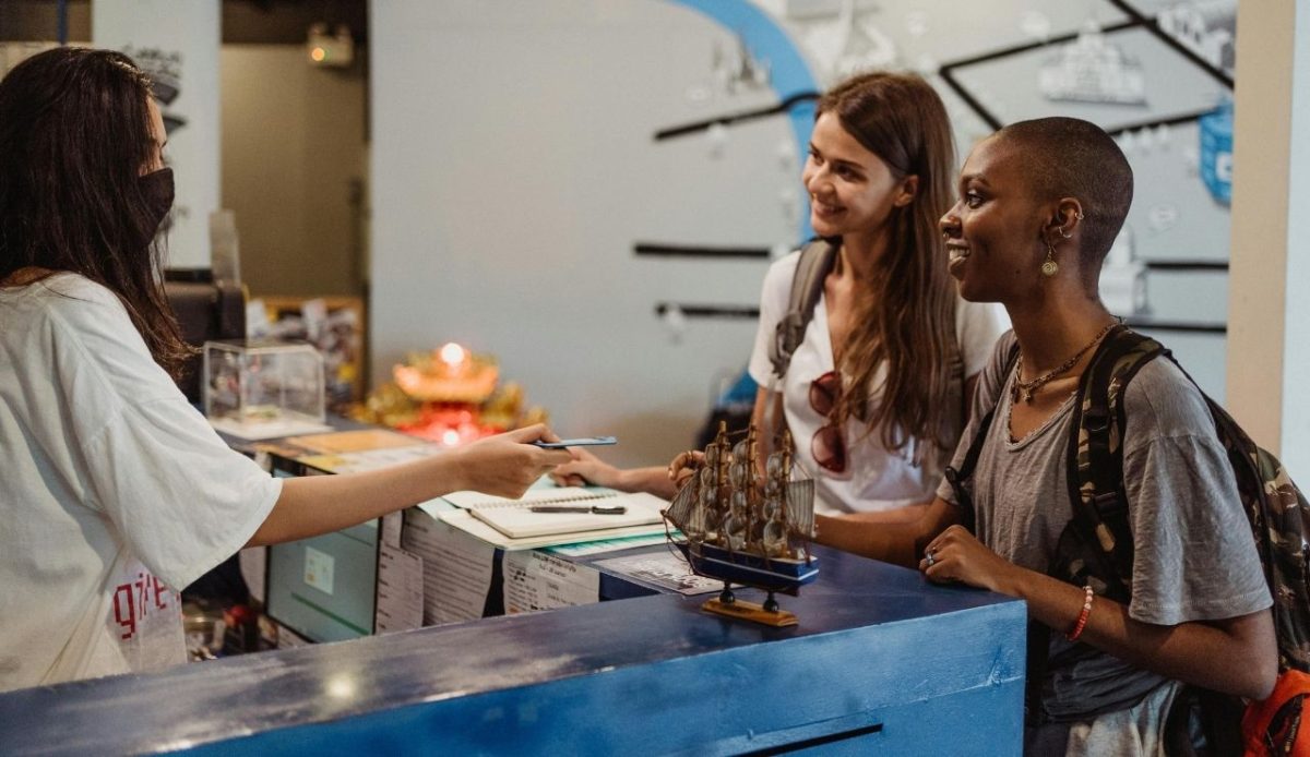 Travelers checking in at hotel reception