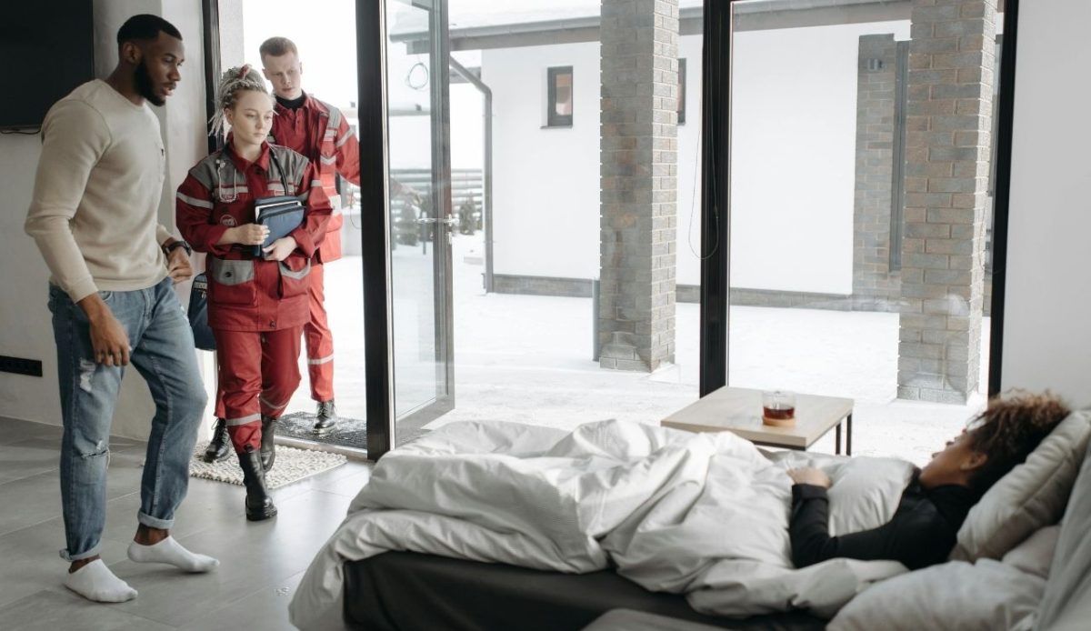 10 Reasons Travelers Sometimes Cancel Their Cruise Plans 2 Two paramedics entering home to assist sick person in bed, winter setting