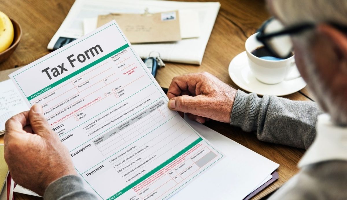 Man reviewing a tax form at desk