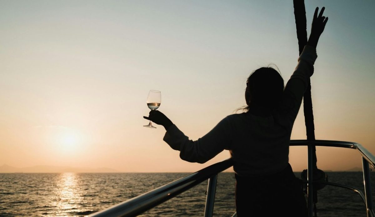 Top Things To Do in St. Thomas, US Virgin Islands 12 Woman with Drink Sailing at Sunset at cruise