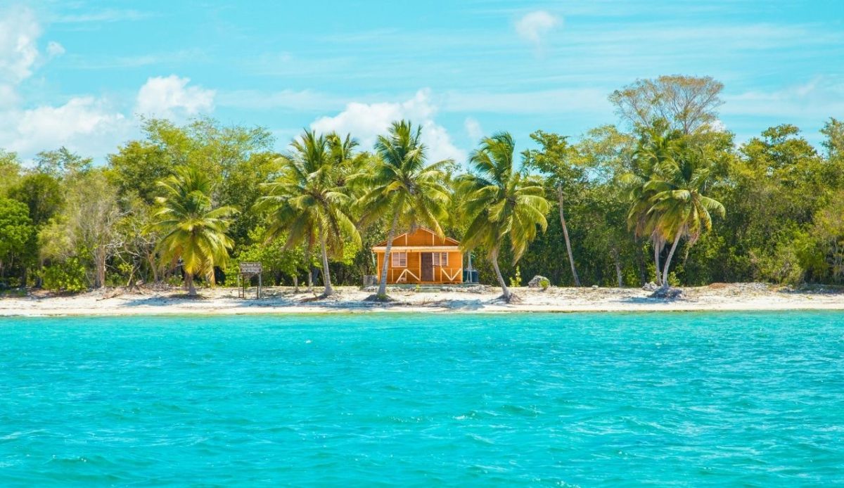 Wooden beach hut with palm trees on Cayo Levantado, Dominican Republic