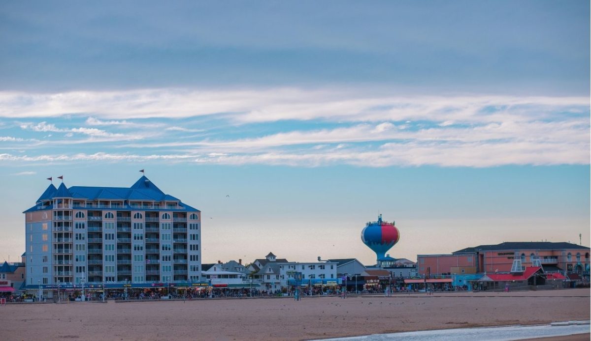 7 Affordable Waterfront Towns Where Retirees Can Live Comfortably on Social Security 7 Beachfront hotels and water tower viewed from the sand, Ocean City, Maryland, USA