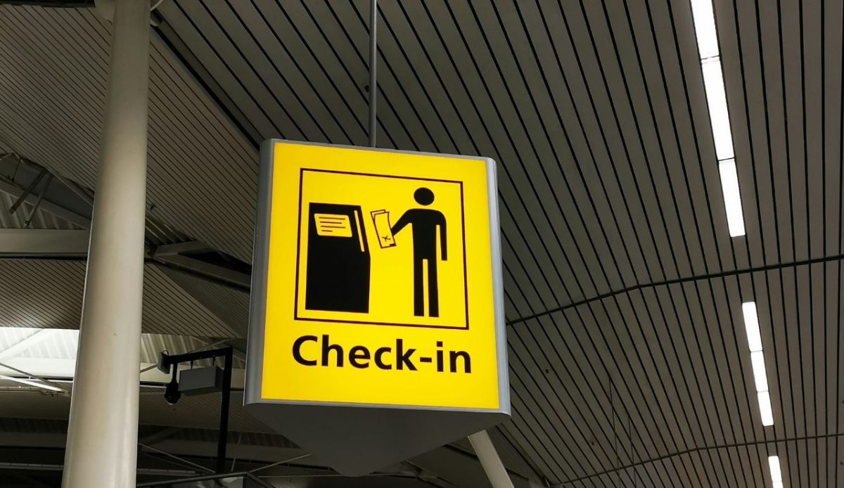 Yellow airport check-in sign