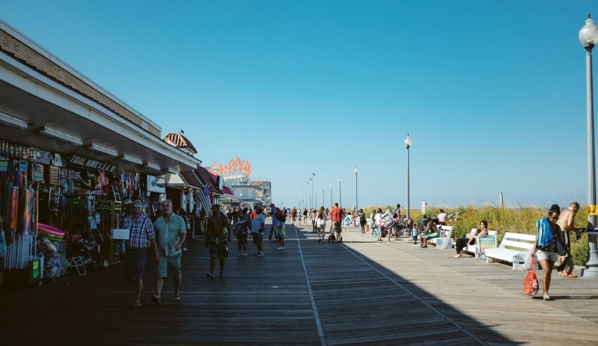 8 Famous East Coast Boardwalks and Beach Towns That Never Get Old 3 People walking along the Rehoboth Beach boardwalk, Delaware, USA